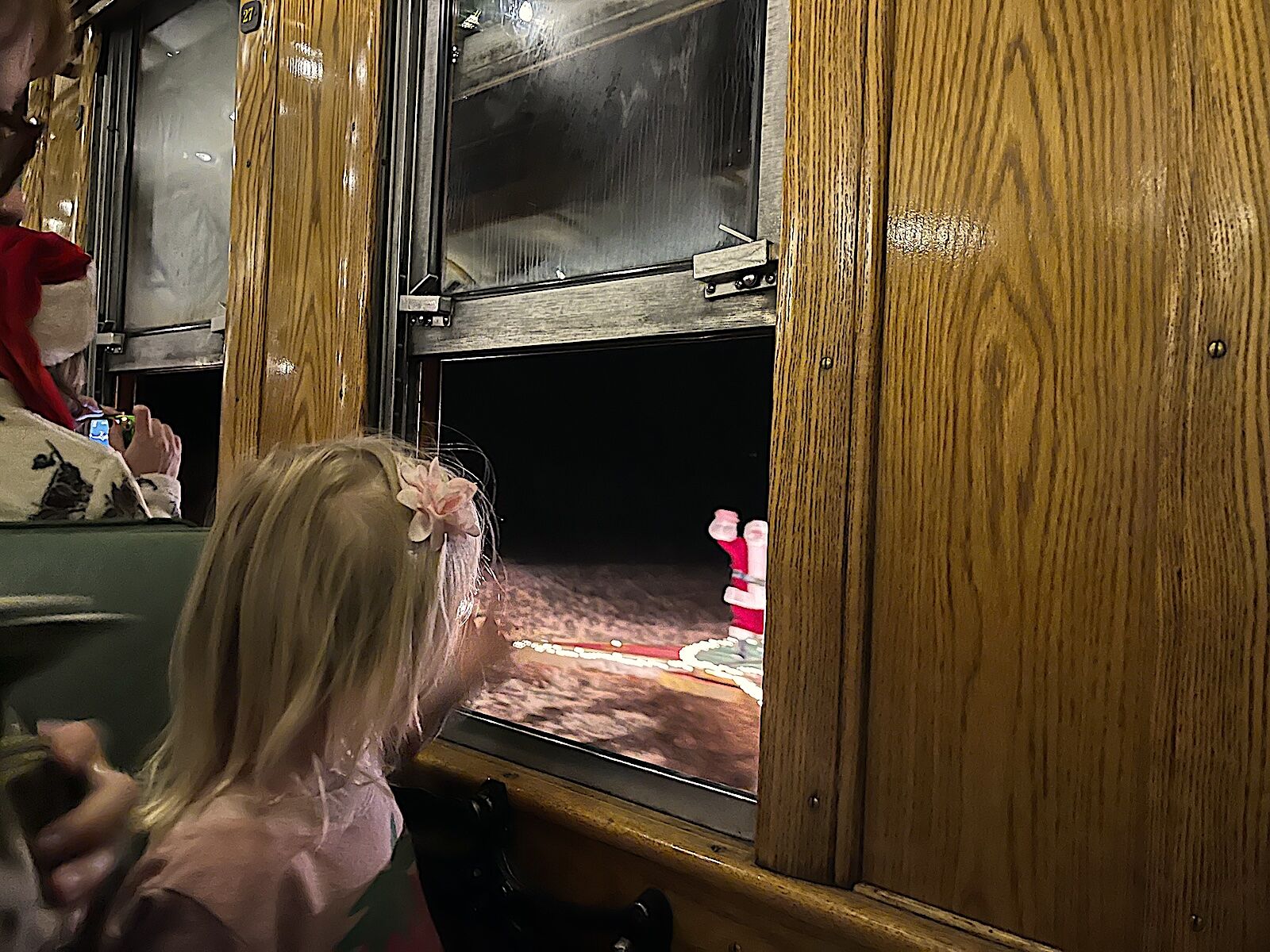 girl spots santa claus out window