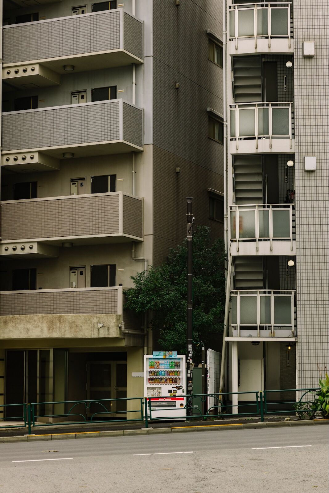 vending machine in japan next to tall buildings