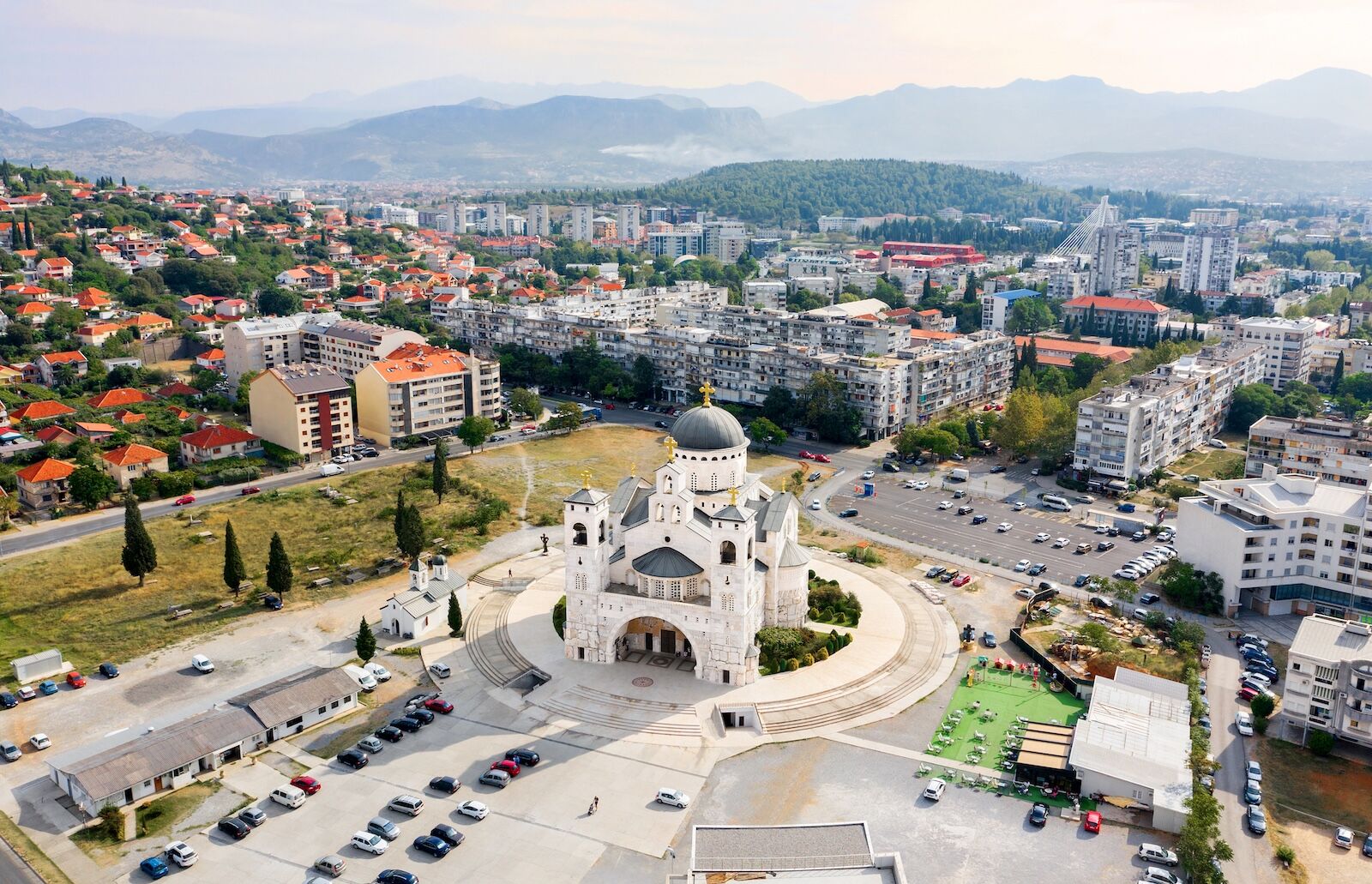 Cathedral of the Resurrection of Christ. Podgorica. Montenegro. 09/19/2020 Top view of the cathedral and the capital of Montenegro - Podgorica. Cathedral in Moshichim. White Temple. Cathedral exterior