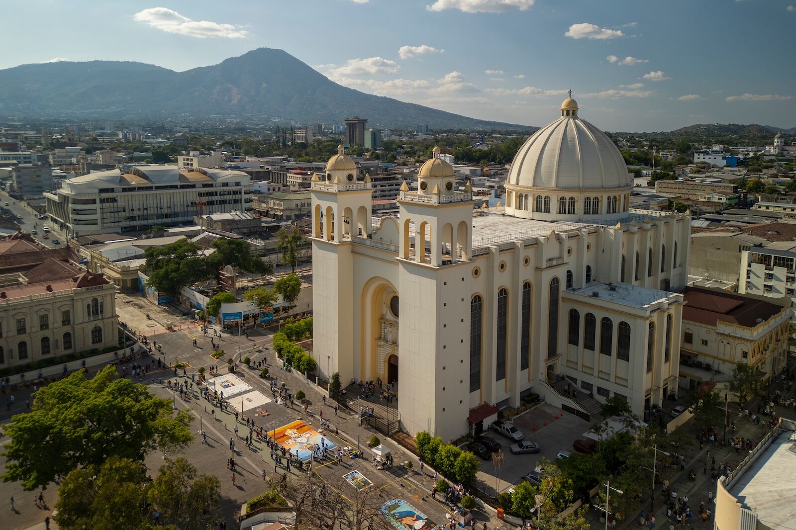 San Salvador, El Salvador Mar 27 2024: Aerial view of the Metropolitan Cathedral during Santa at main square of historical city center with mountains and volcanoes in the background.