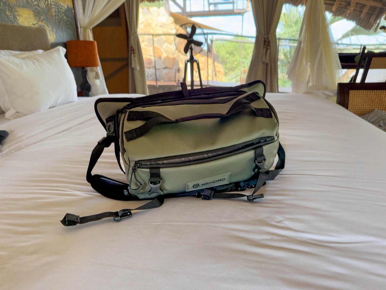 wandrd camera sling bag on bed 