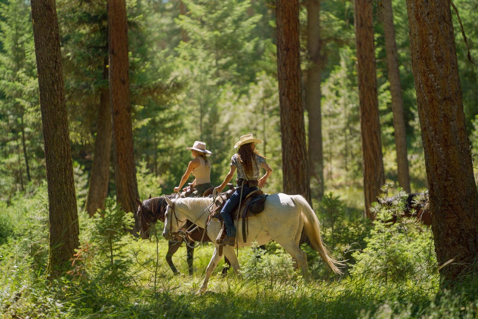 women on horseback at paws up montana