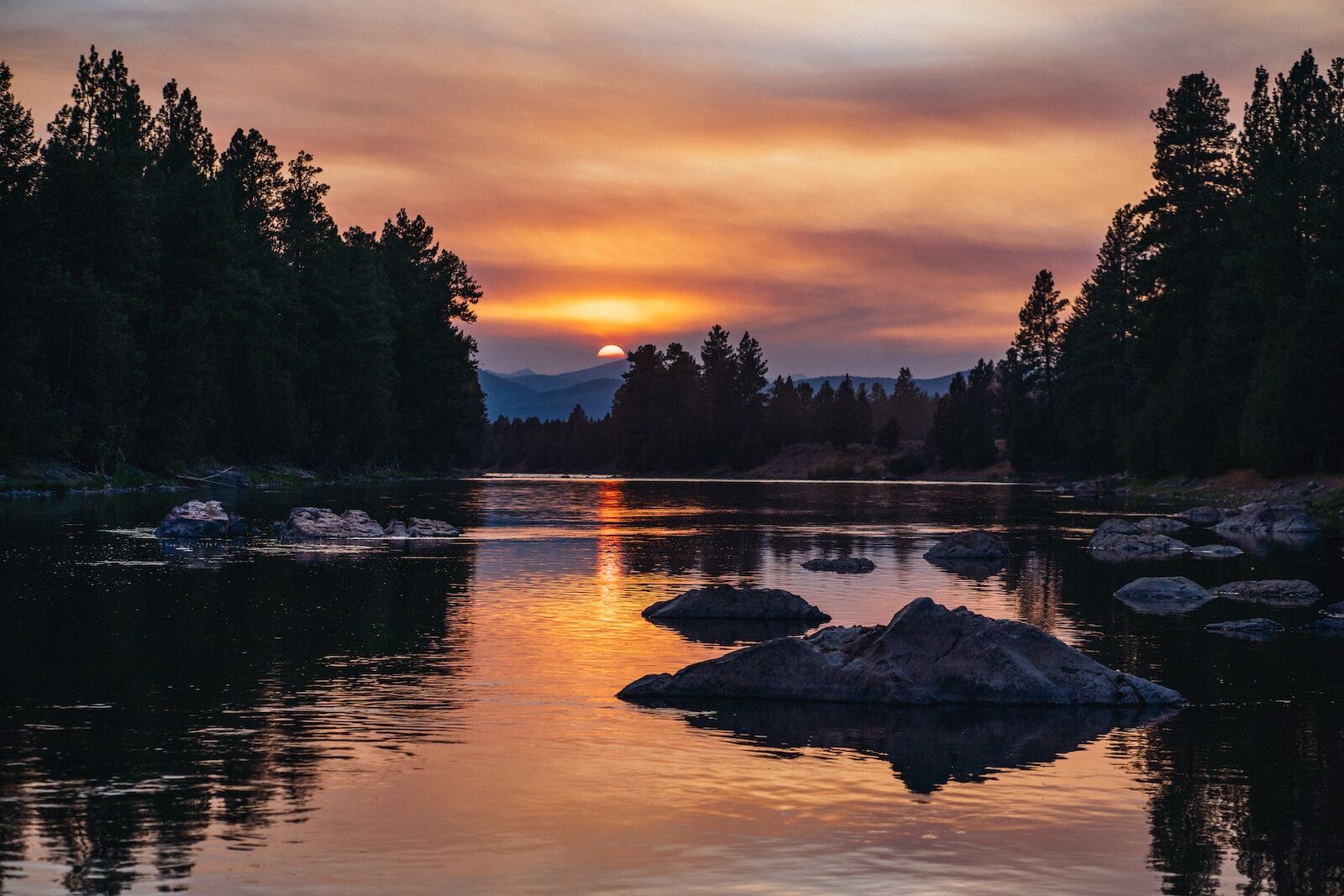 sunset over lake at paws up montana