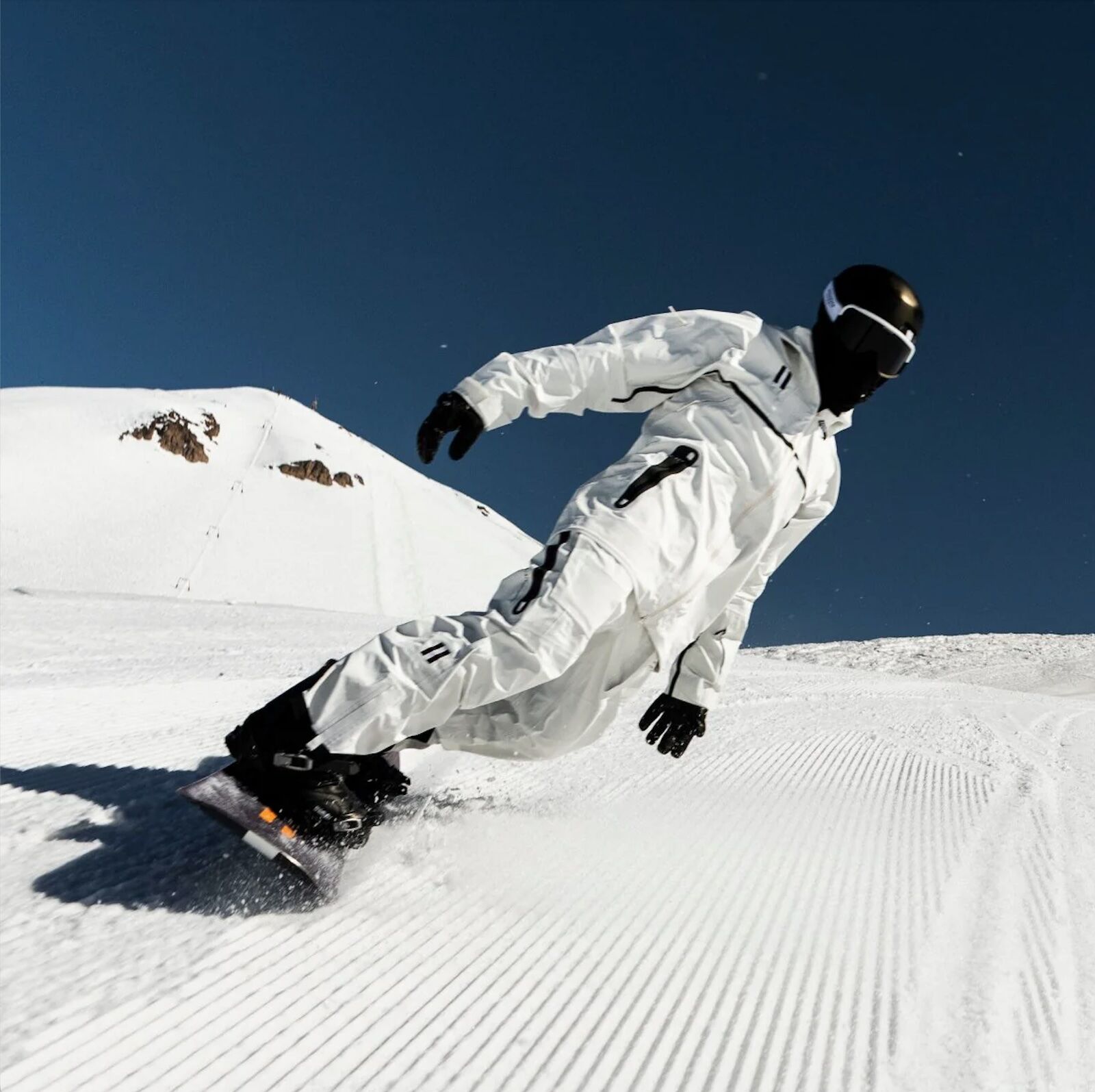 snowboarder riding in whitespace 3L performance jacket