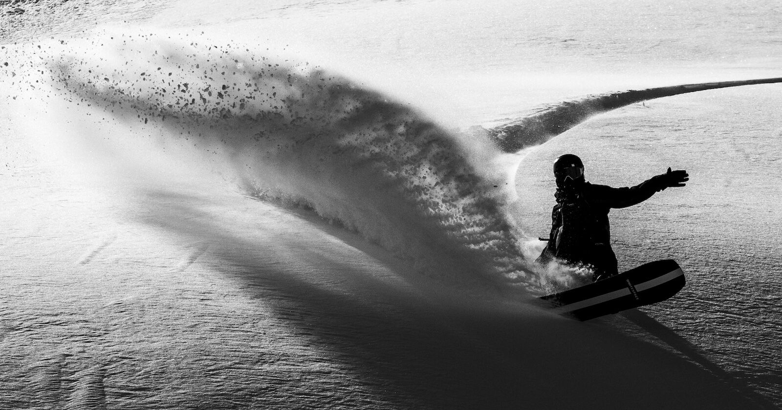 snowboarder riding in powder