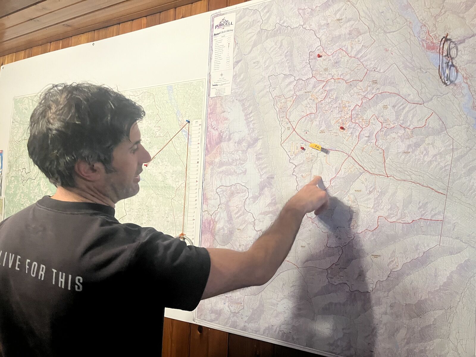 man points to heli-ski map