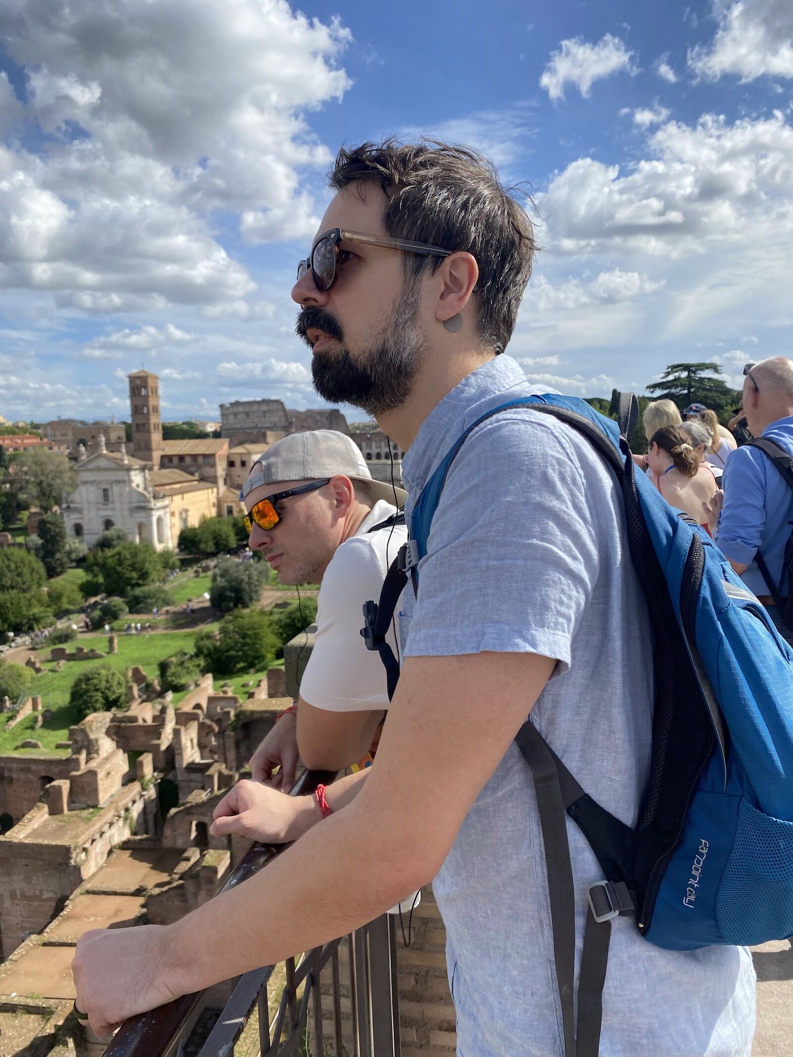 man wearing osprey farpoint backpack