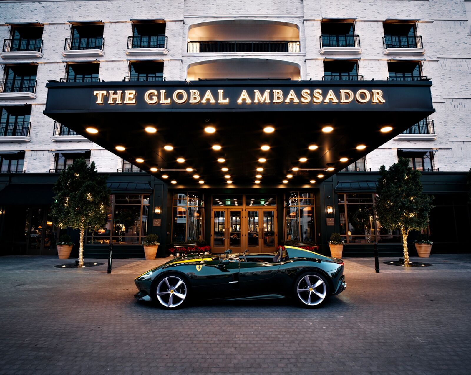 luxury car in front of the global ambassador hotel