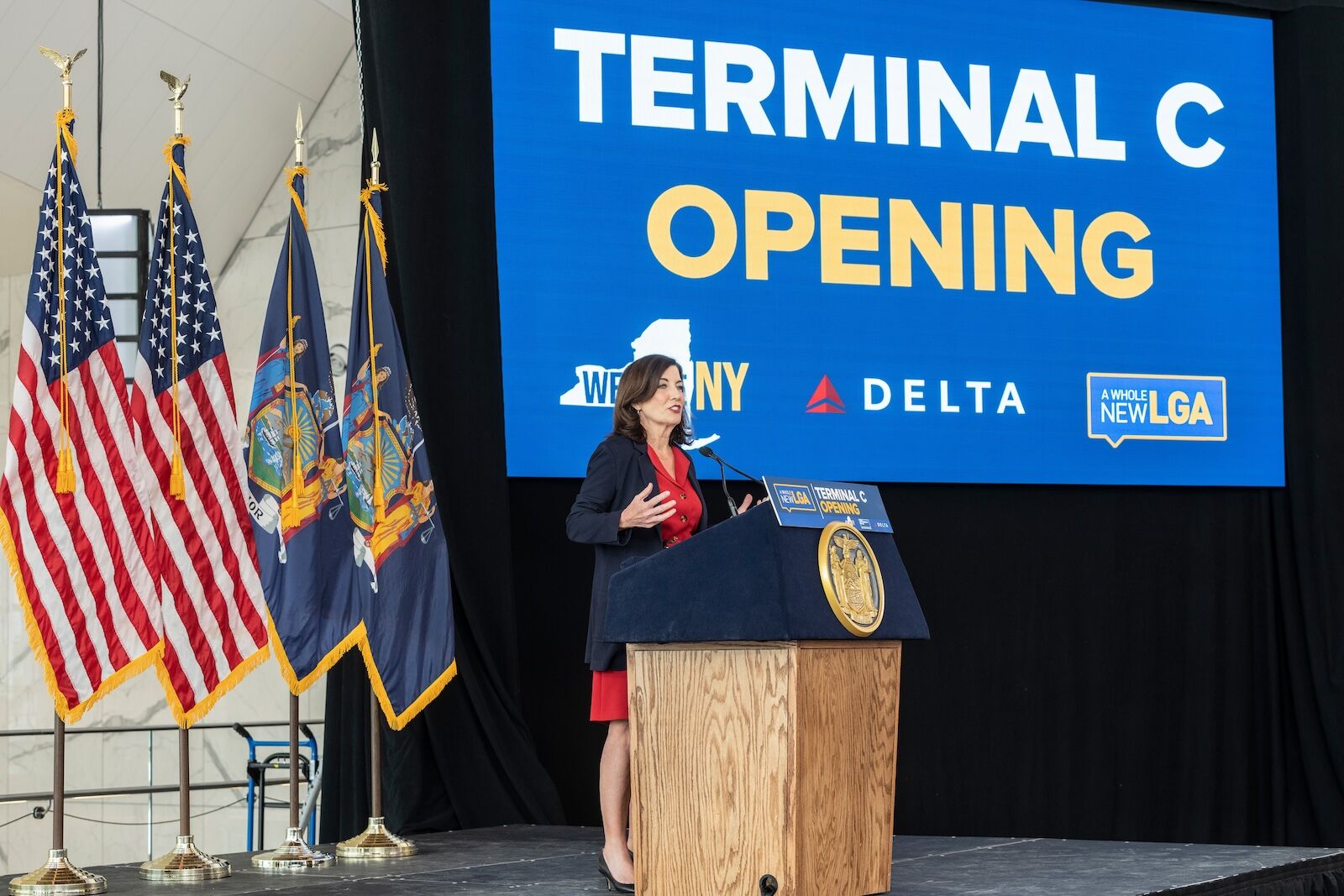 woman speaks at opening of laguardia terminal C