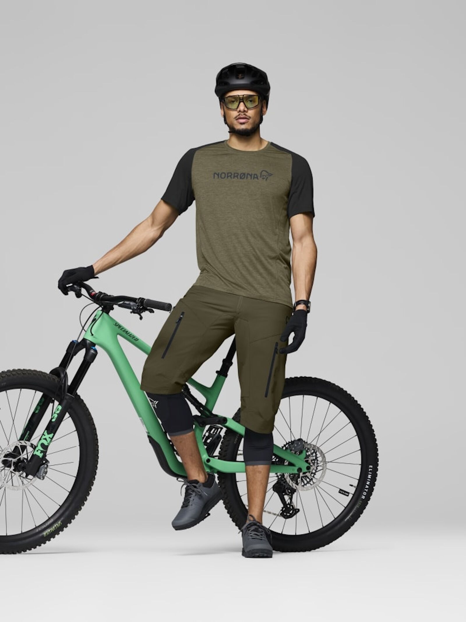 mountain biker in norrona jersey and shorts with bike
