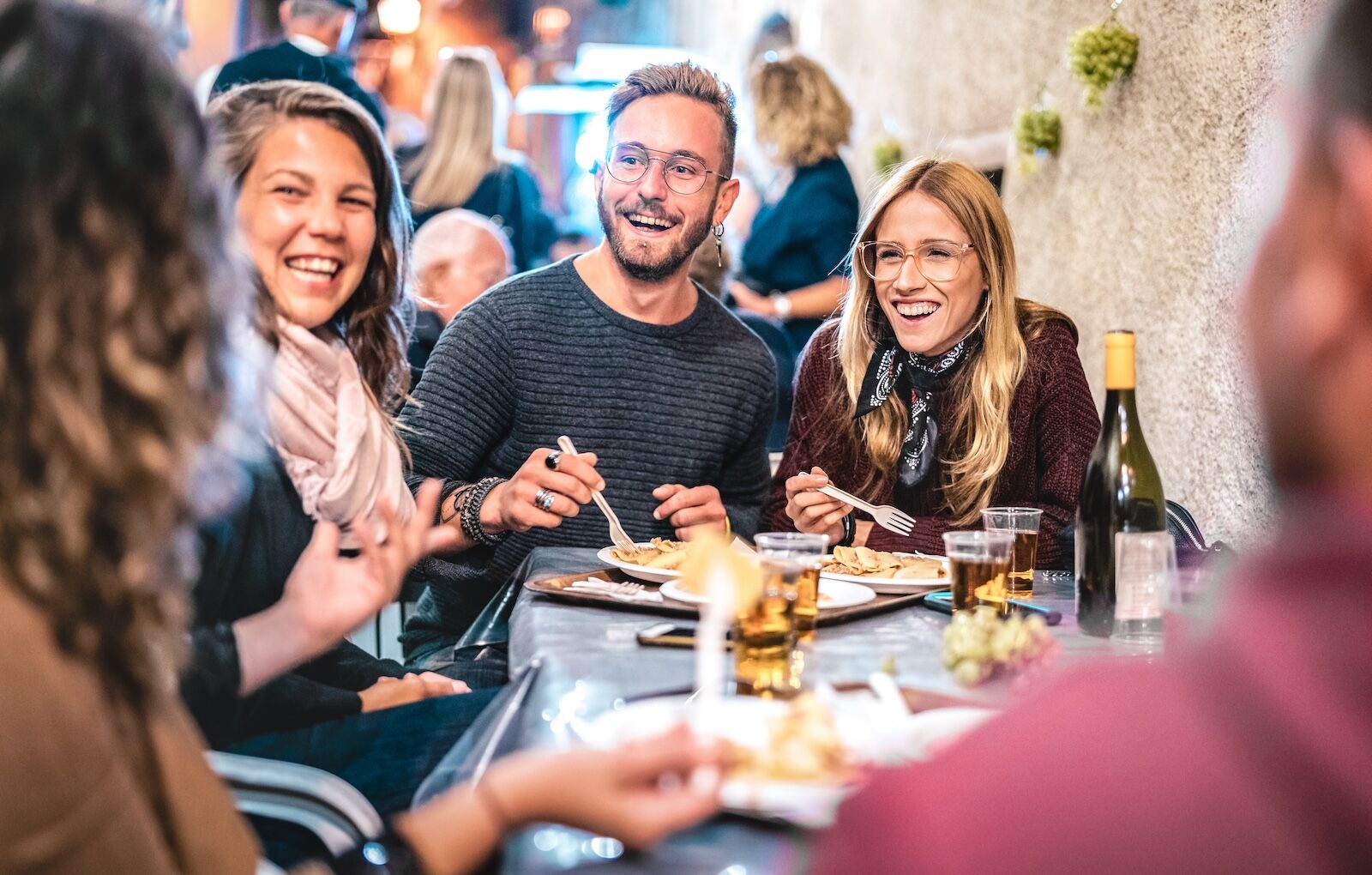 millennial group travel - people at dinner