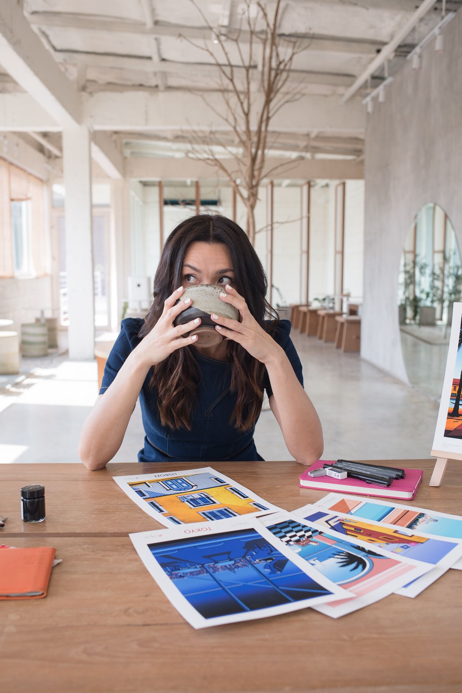 woman drinking coffee at desk