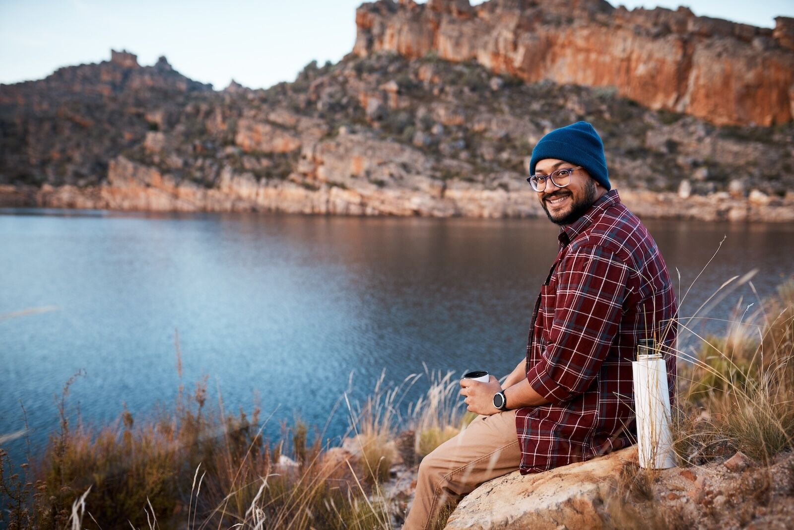 how to stay warm while camping - man wearing beanie and flannel