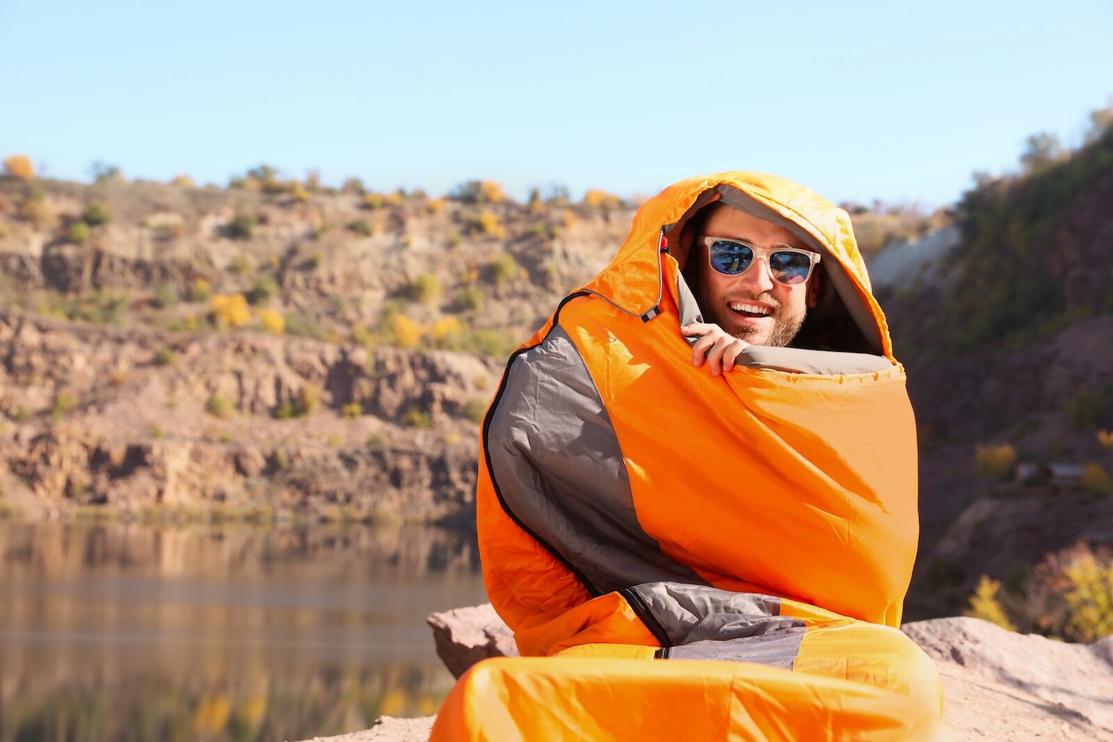 how to stay warm while camping - guy in sleeping bag