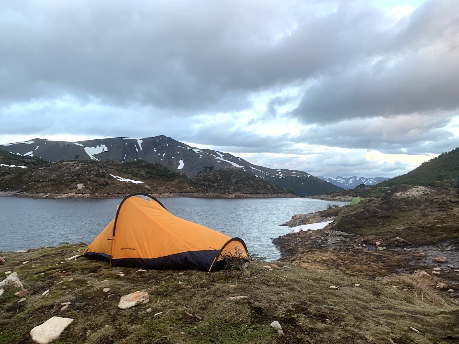 how to stay warm while camping - tent on lake in patagonia