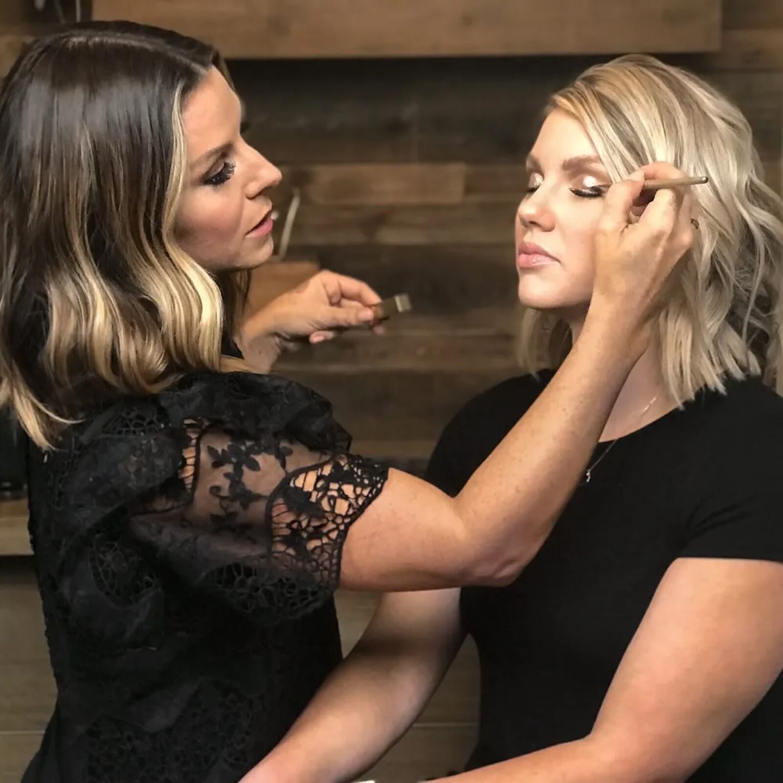 jill powell applying makeup on a woman