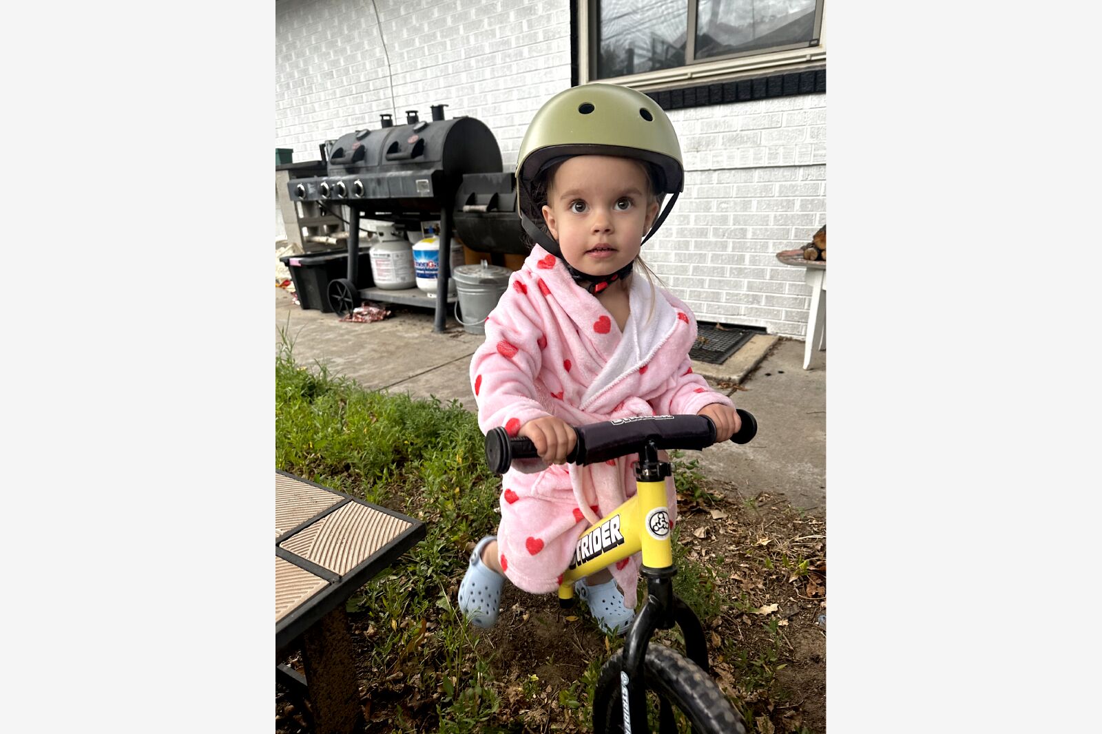 toddler riding a strider bike