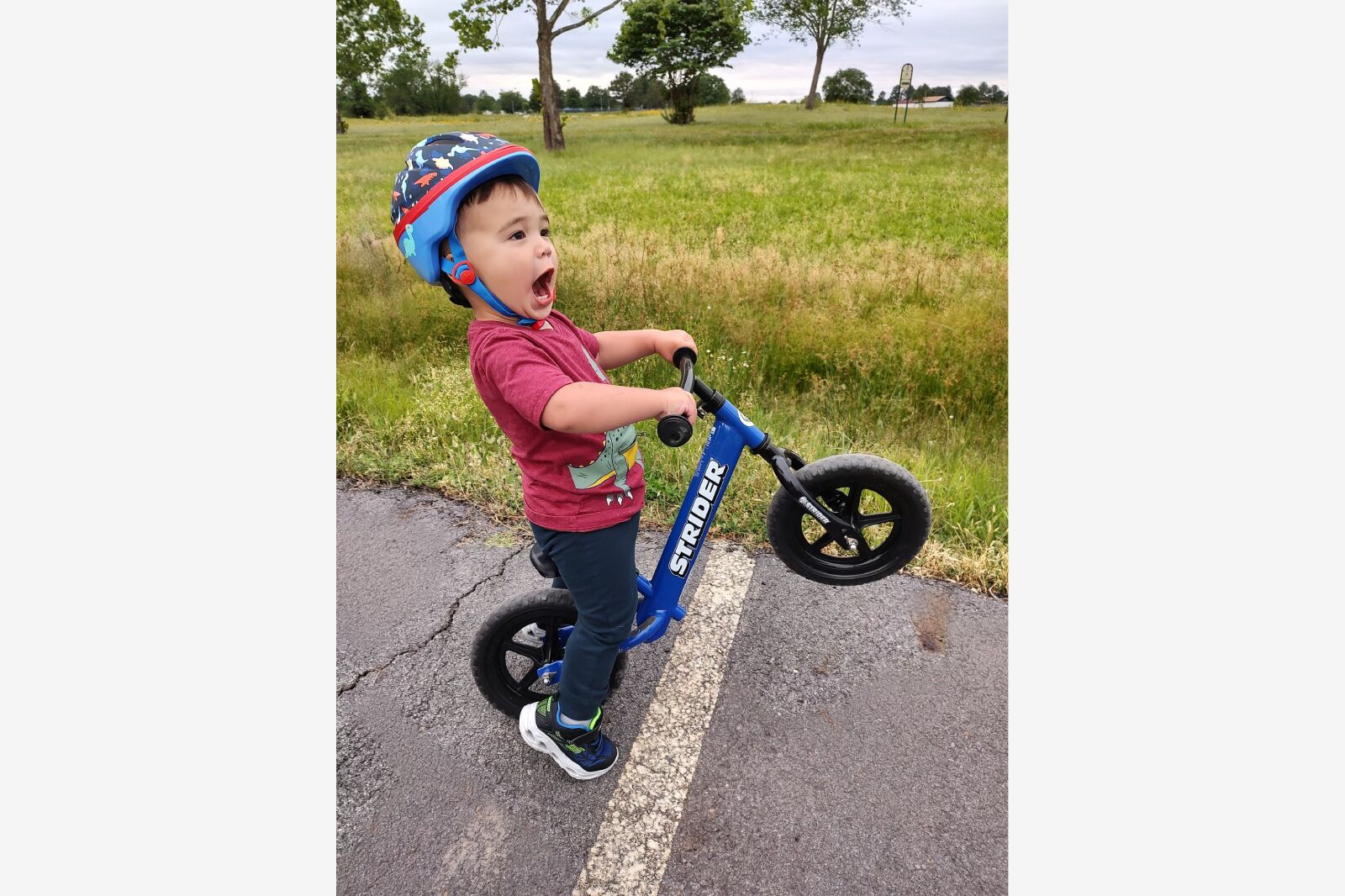 toddler riding a strider bike
