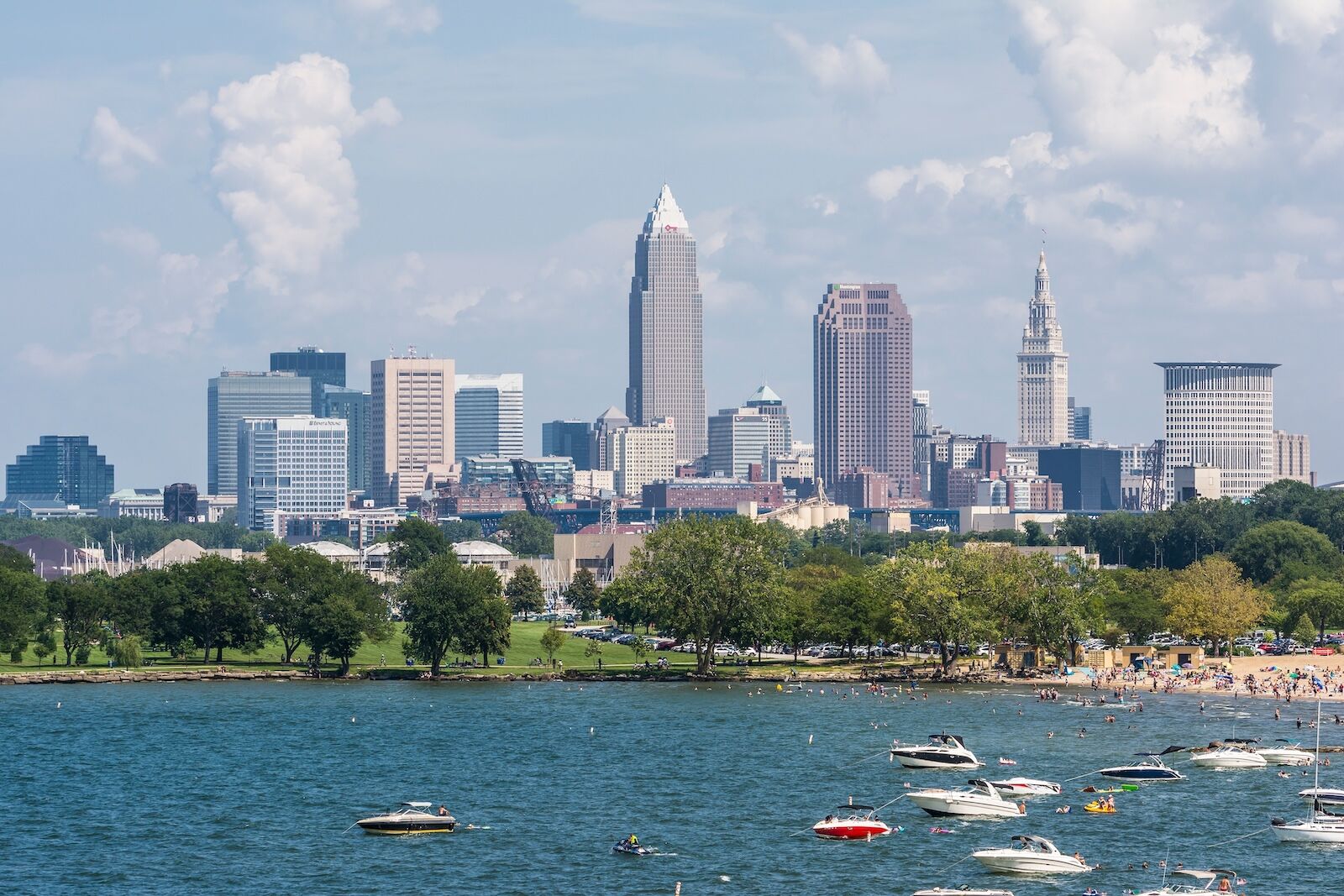 boats on lake in front of cleveland skyline
