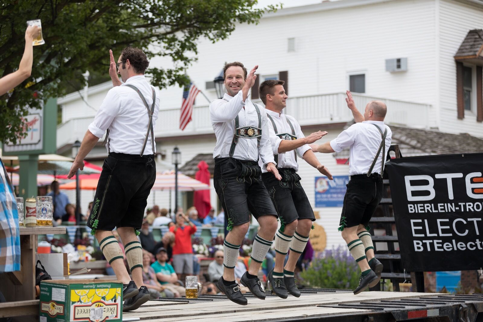 Frankenmuth, Michigan, USA - June 10, 2018 Men and women playing traditional german music drinking beer dancing and wearing traditional german clothing at the Bavarian Festival Parade.