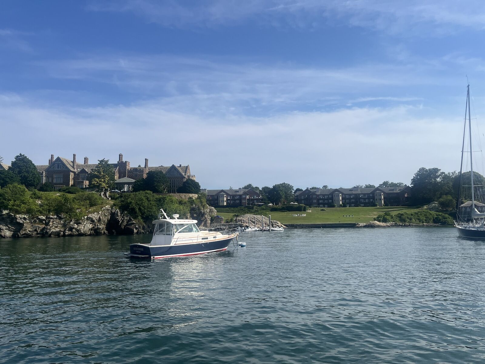 boat in front of mansion in newport, rhode island