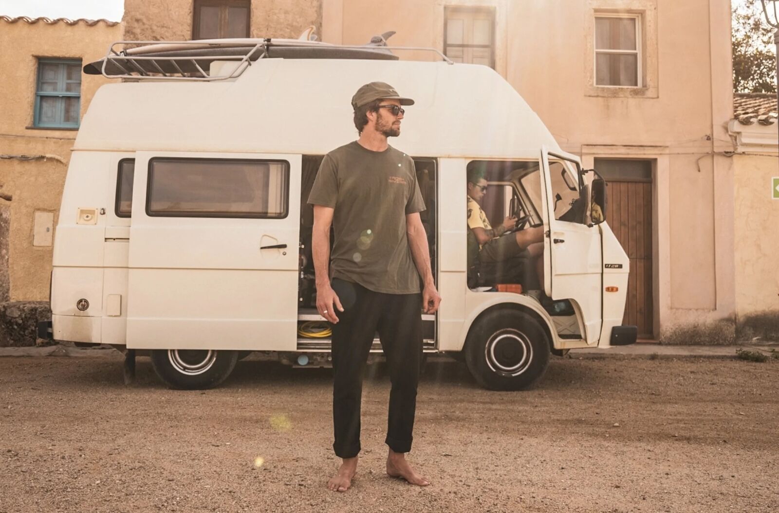 man in roark layover pant in front of van