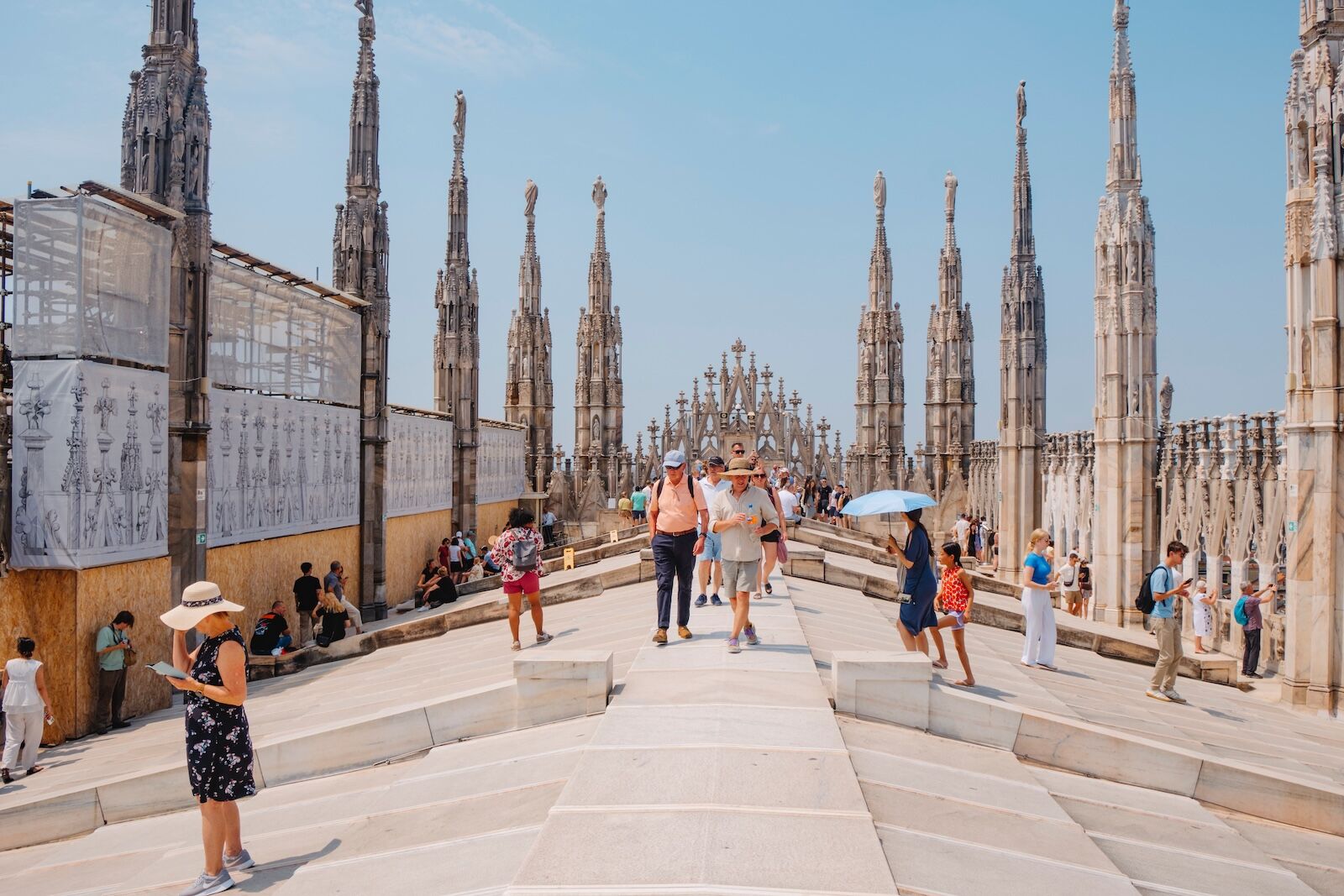 people on top of the milan cathedral