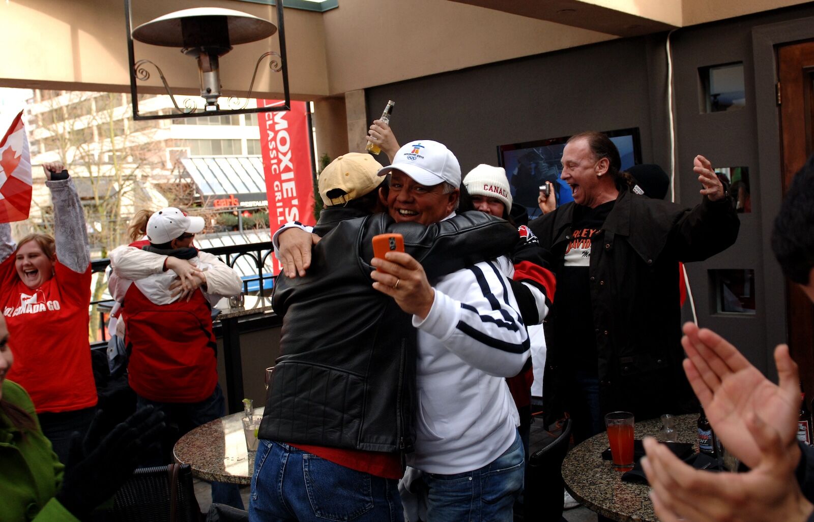 people hugging at sports bar in vancouver
