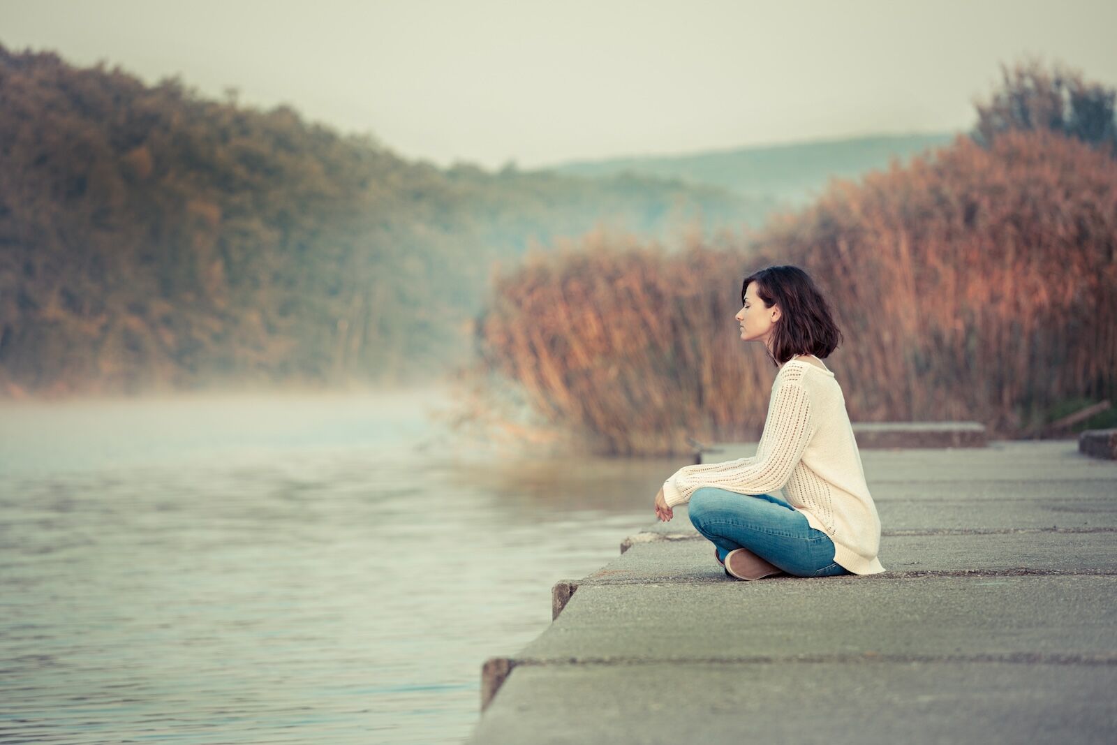 woman sitting on a dock in silence