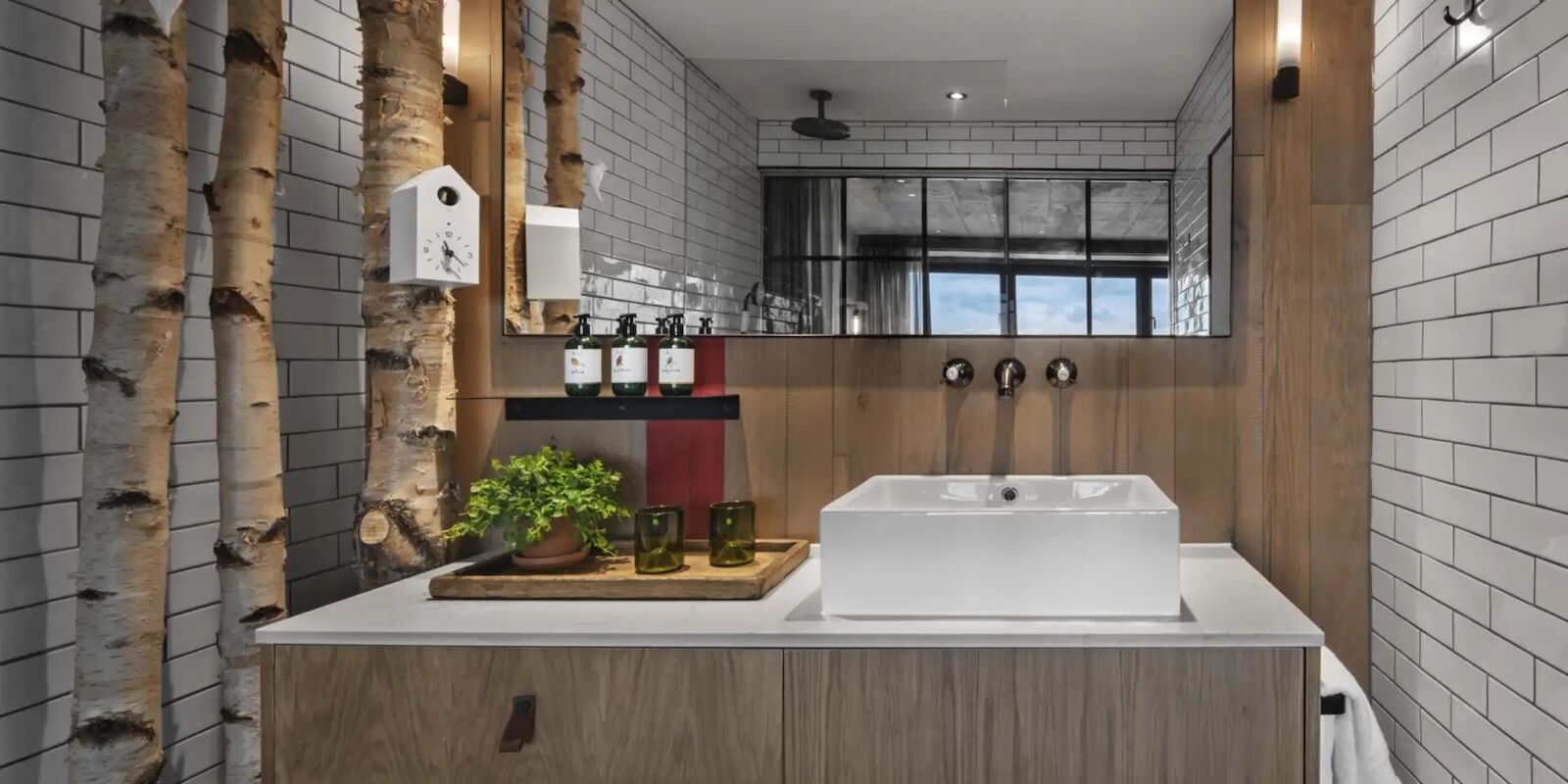 trees in bathroom at treehouse hotel london