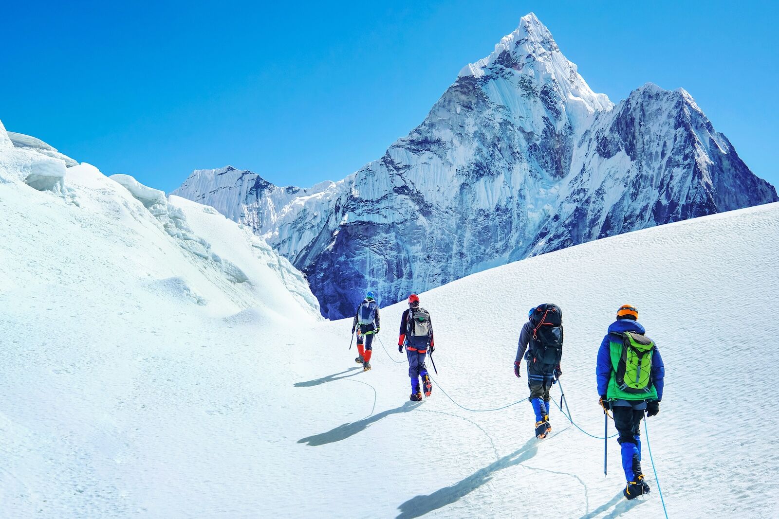 mountaineers traversing snowy slope