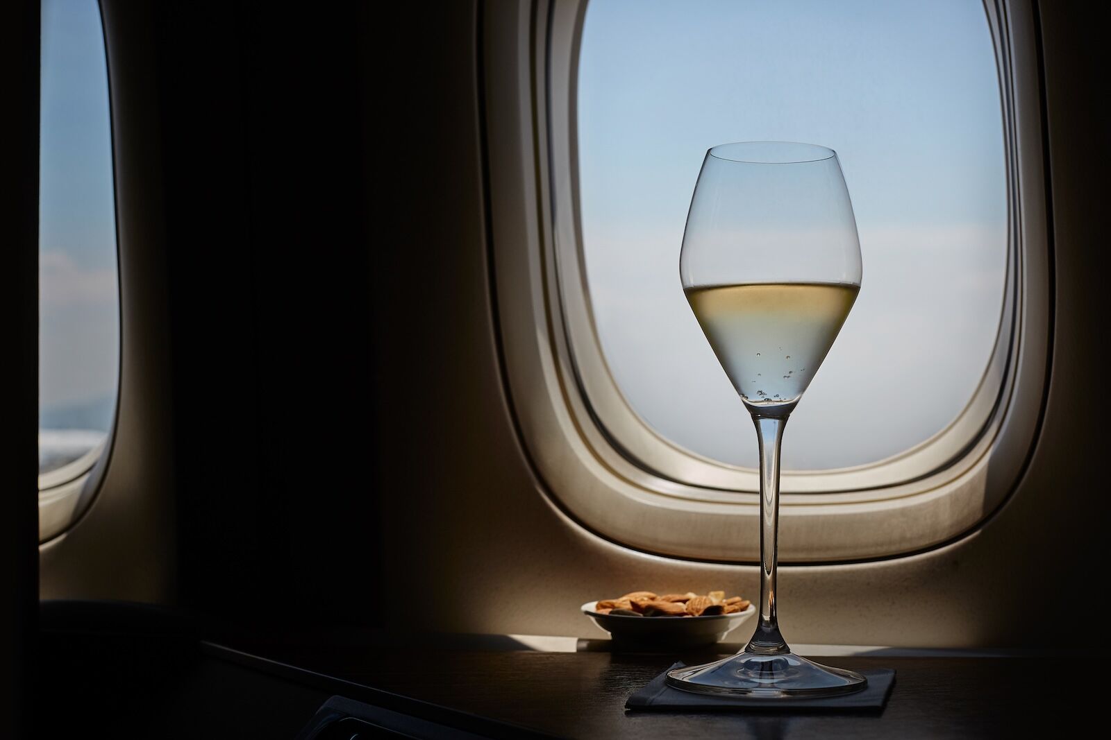 sparkling wine with airplane window backdrop