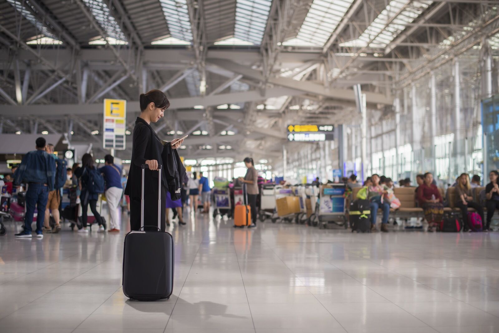 woman with luggage at airport