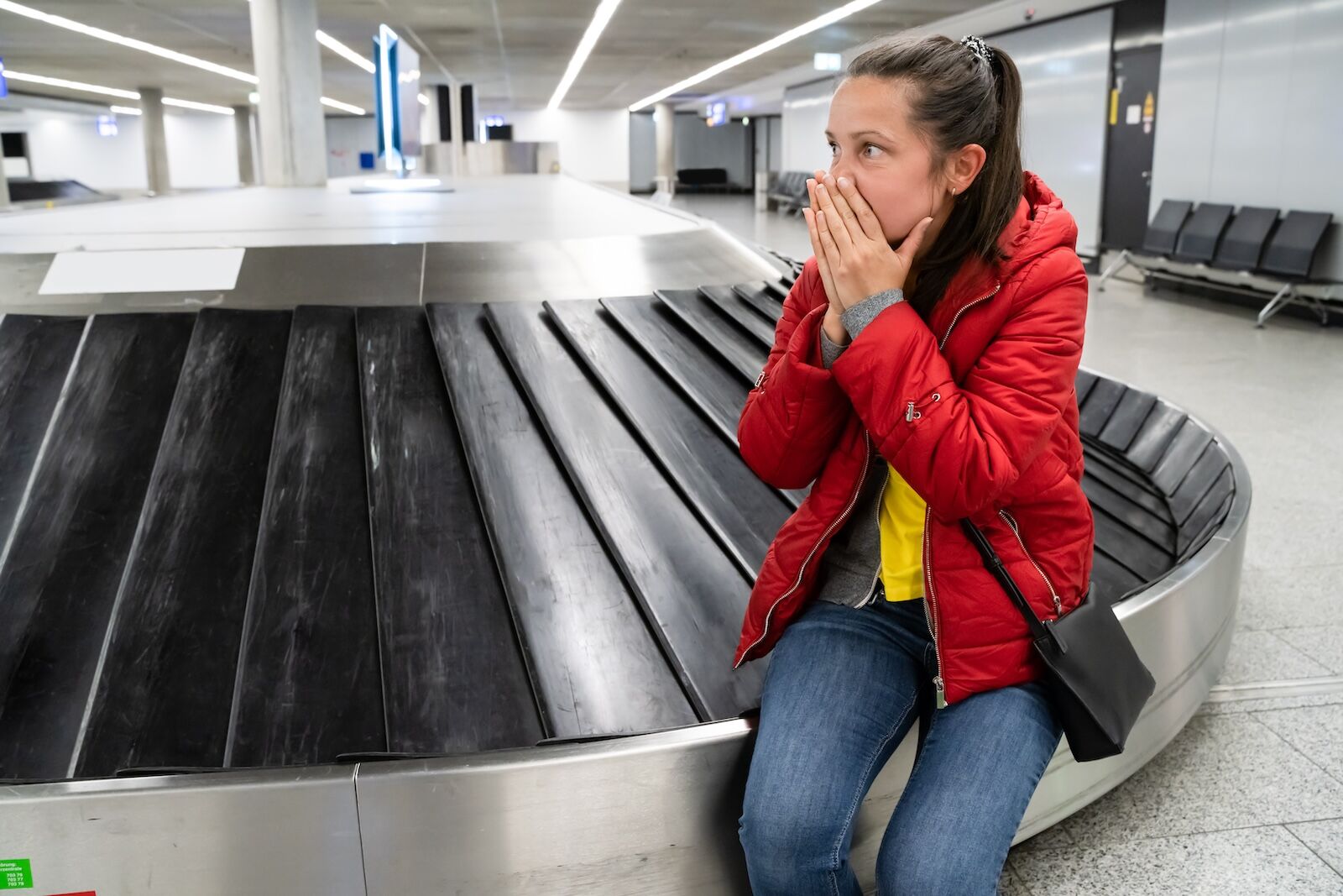 upset woman at baggage carousel