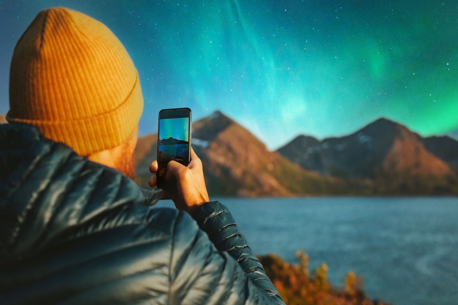 2025 northern lights -2025 aurora year - person shooting with smartphone