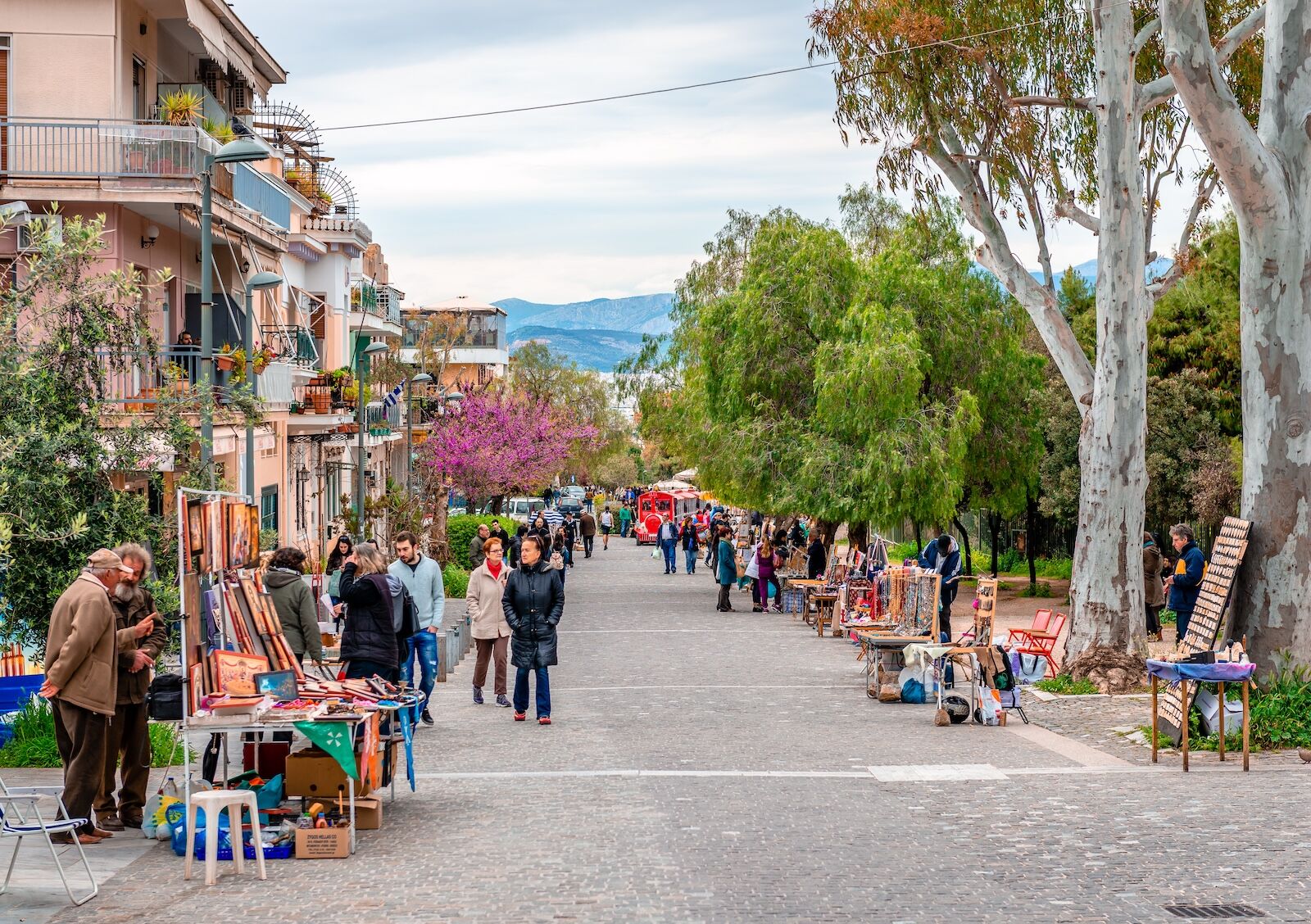 Athens, Greece - April 4 2015: View of Apostolou Pavlou St, the pedestrian zone that goes around the Acropolis Hill, at Thiseio district. Flee market, incidental people.