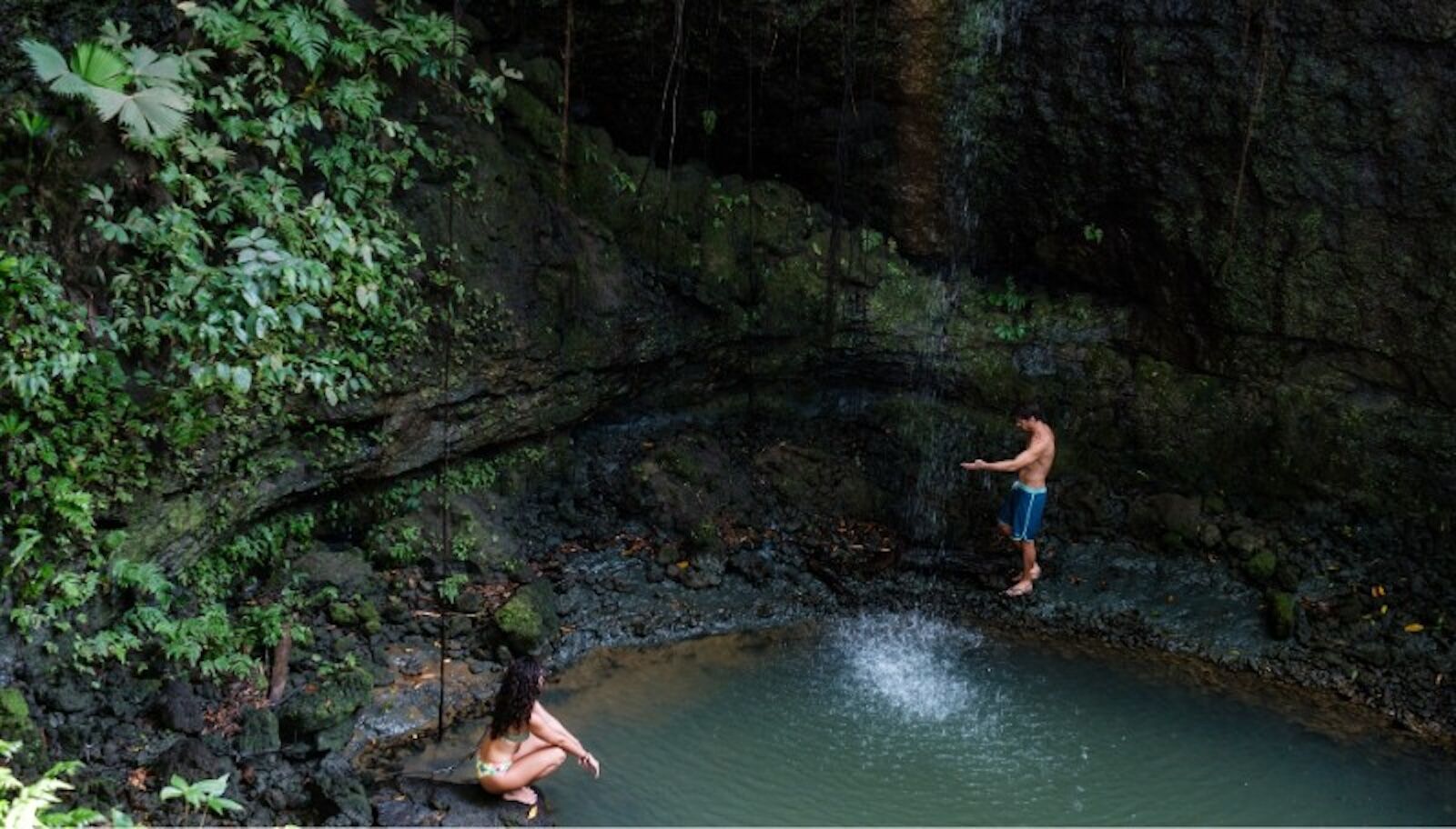 waterfall with people in corcovado national park