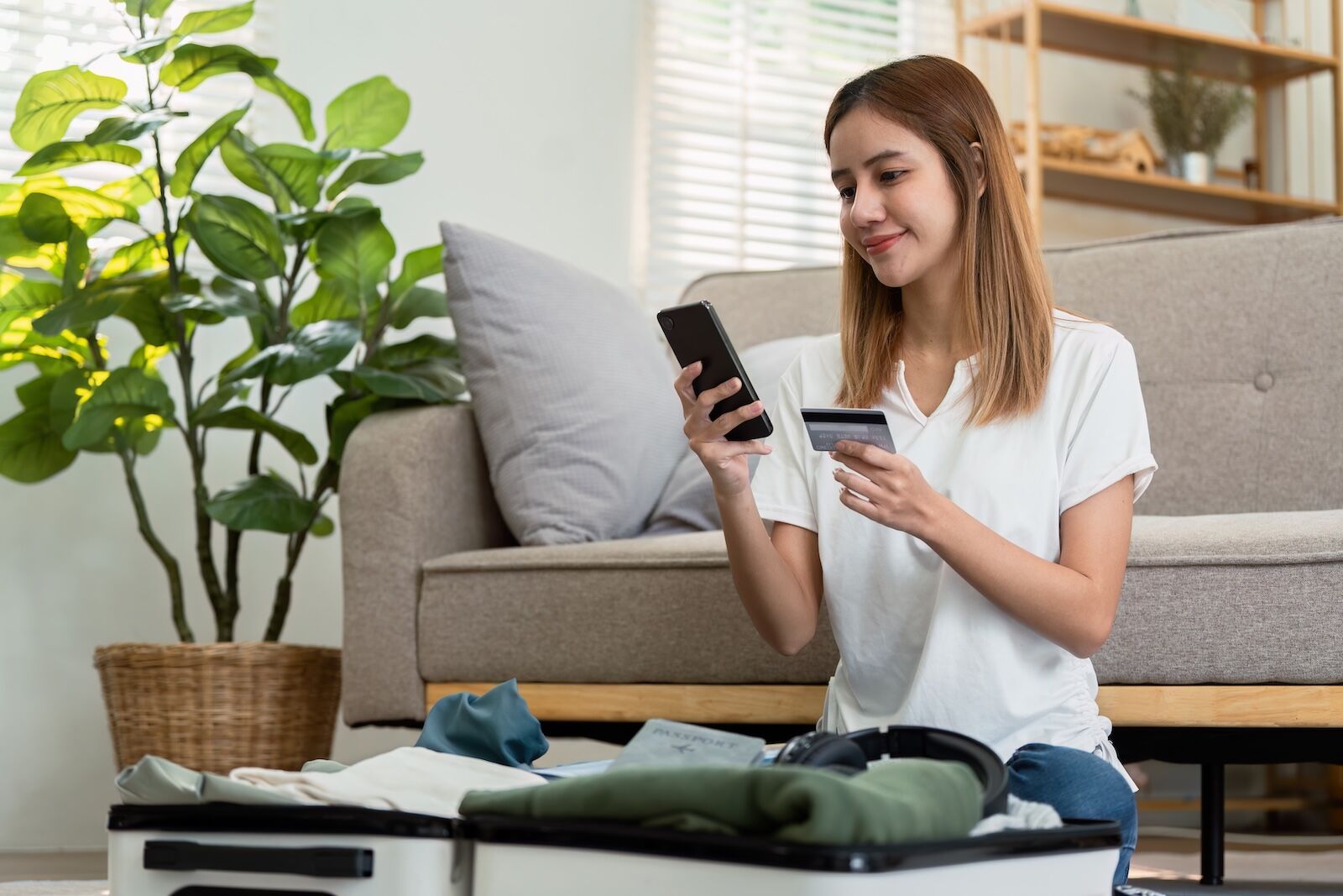 woman with credit card on phone