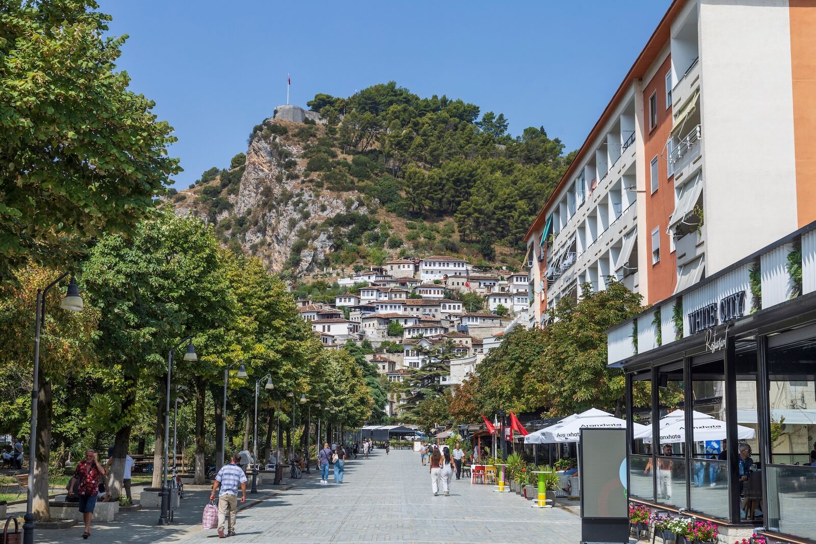 Tourists and local people in the Bulevardi Republika (Republic Boulevard), a charming main street in the heart of Berat, also called the City of Thousand Windows.