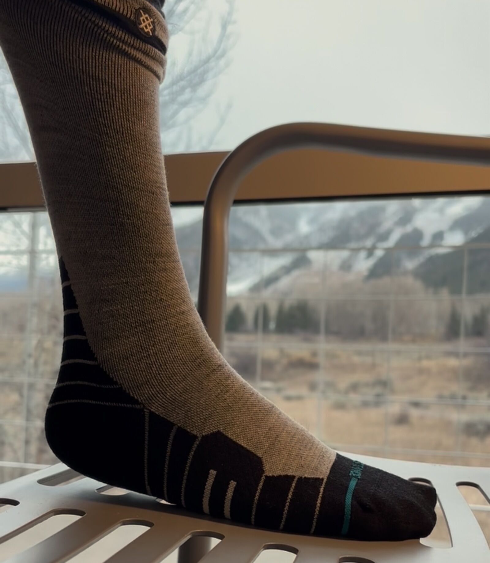 foot and leg with stance ski sock on chair