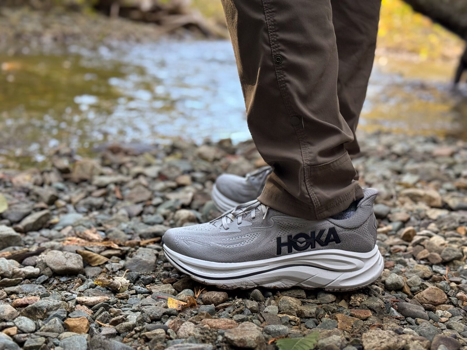 travel running gear - hokas on pebbles