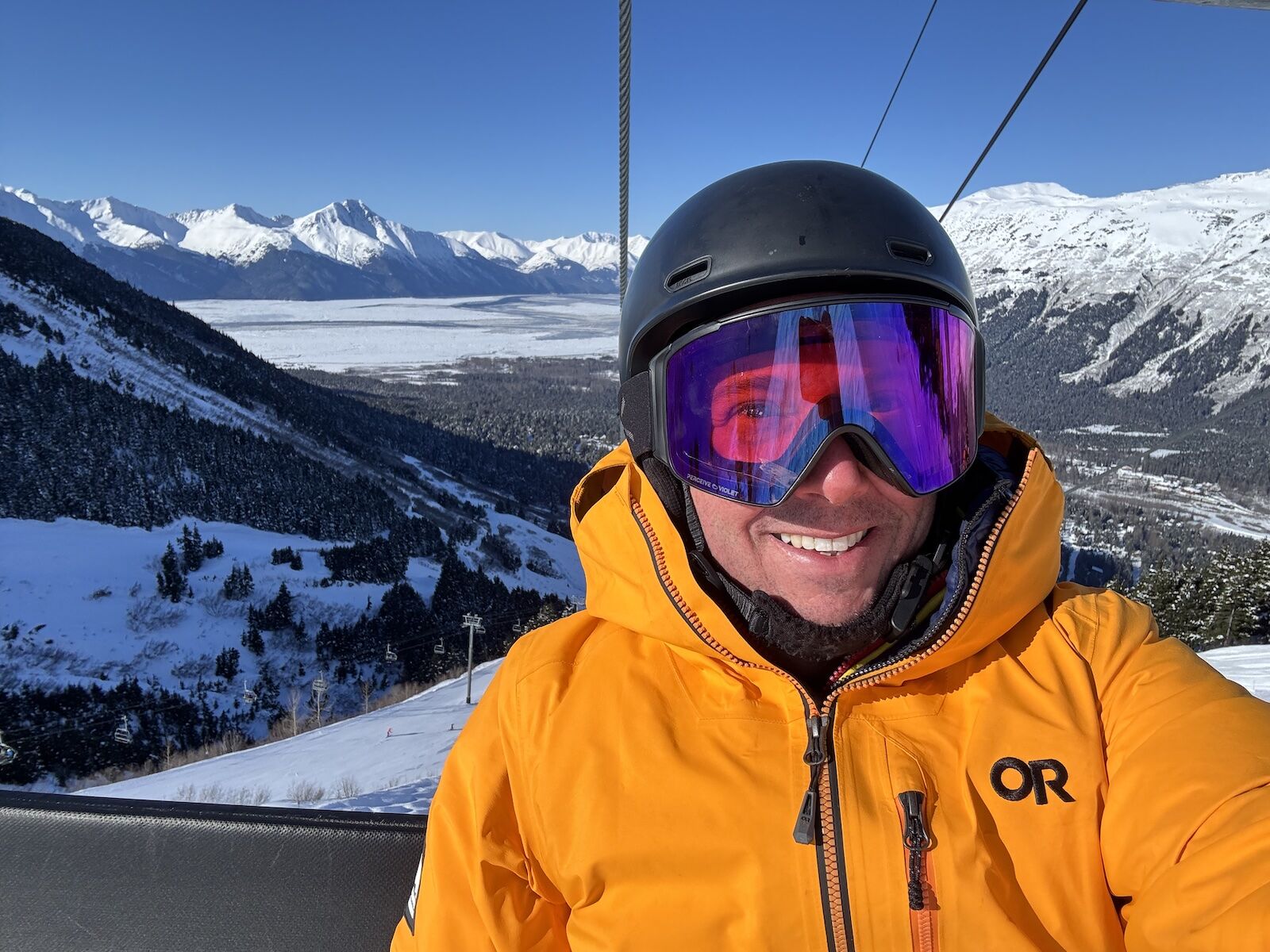 snowboarder on chairlift at alyeska