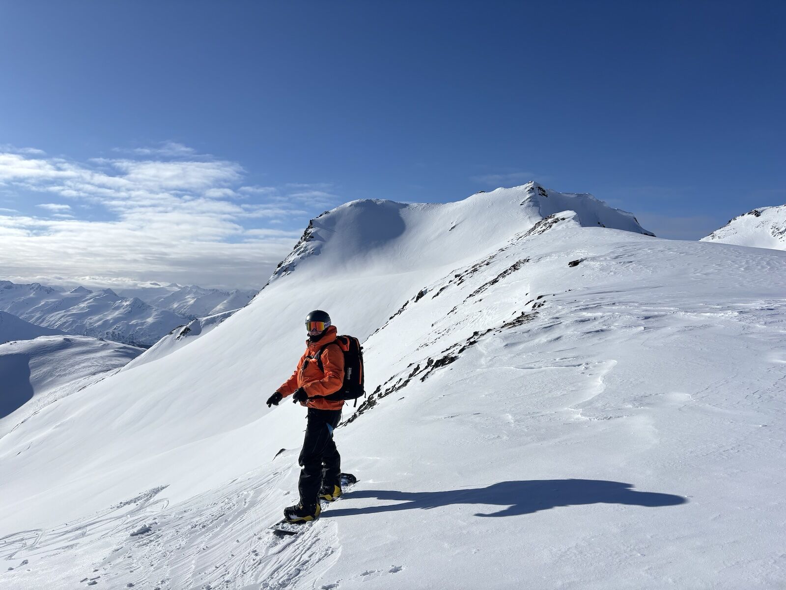 snowboarder on peak in alaska