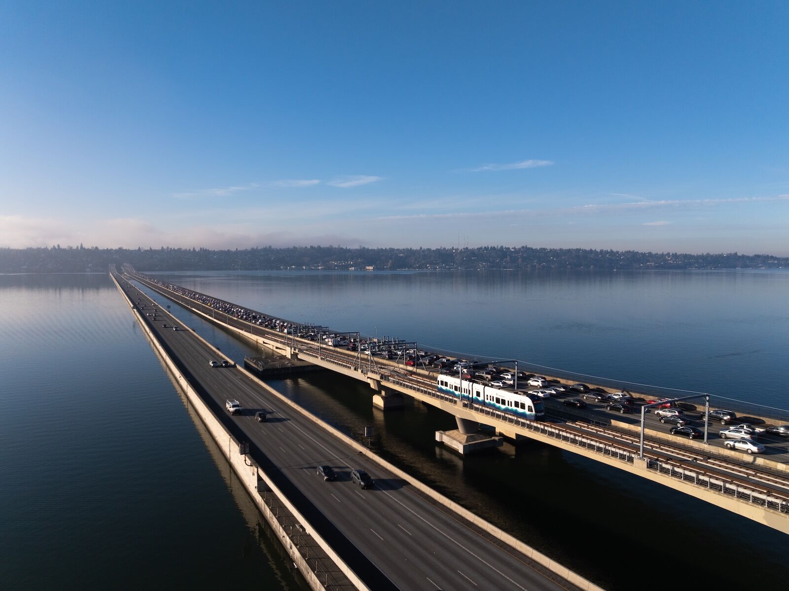 A one-car train crosses the I-90 floating bridge during pre-revenue operations on December 31, 2025.