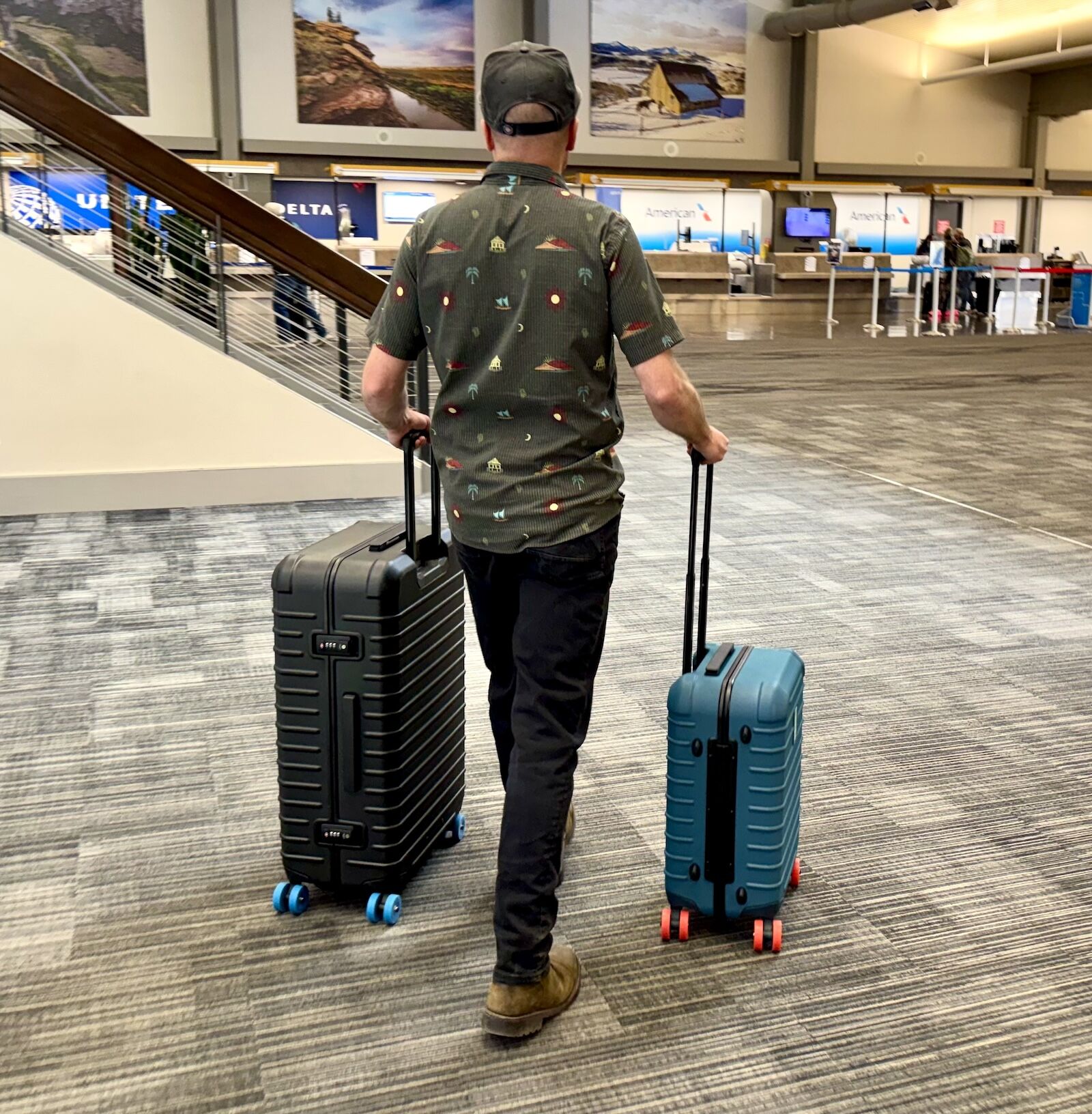 man walking through airport with cotopaxi coraza luggage