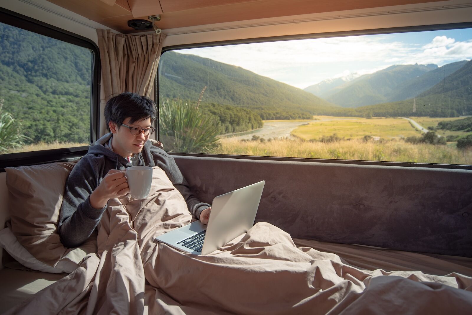 man doing remote work in van in new zealand
