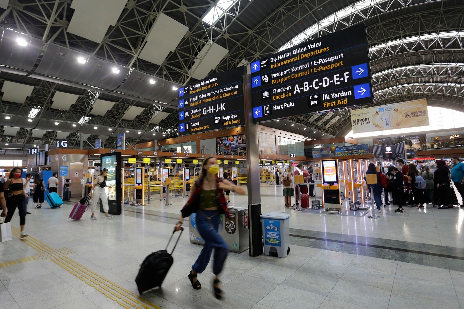 airport lost luggage - woman running through airport