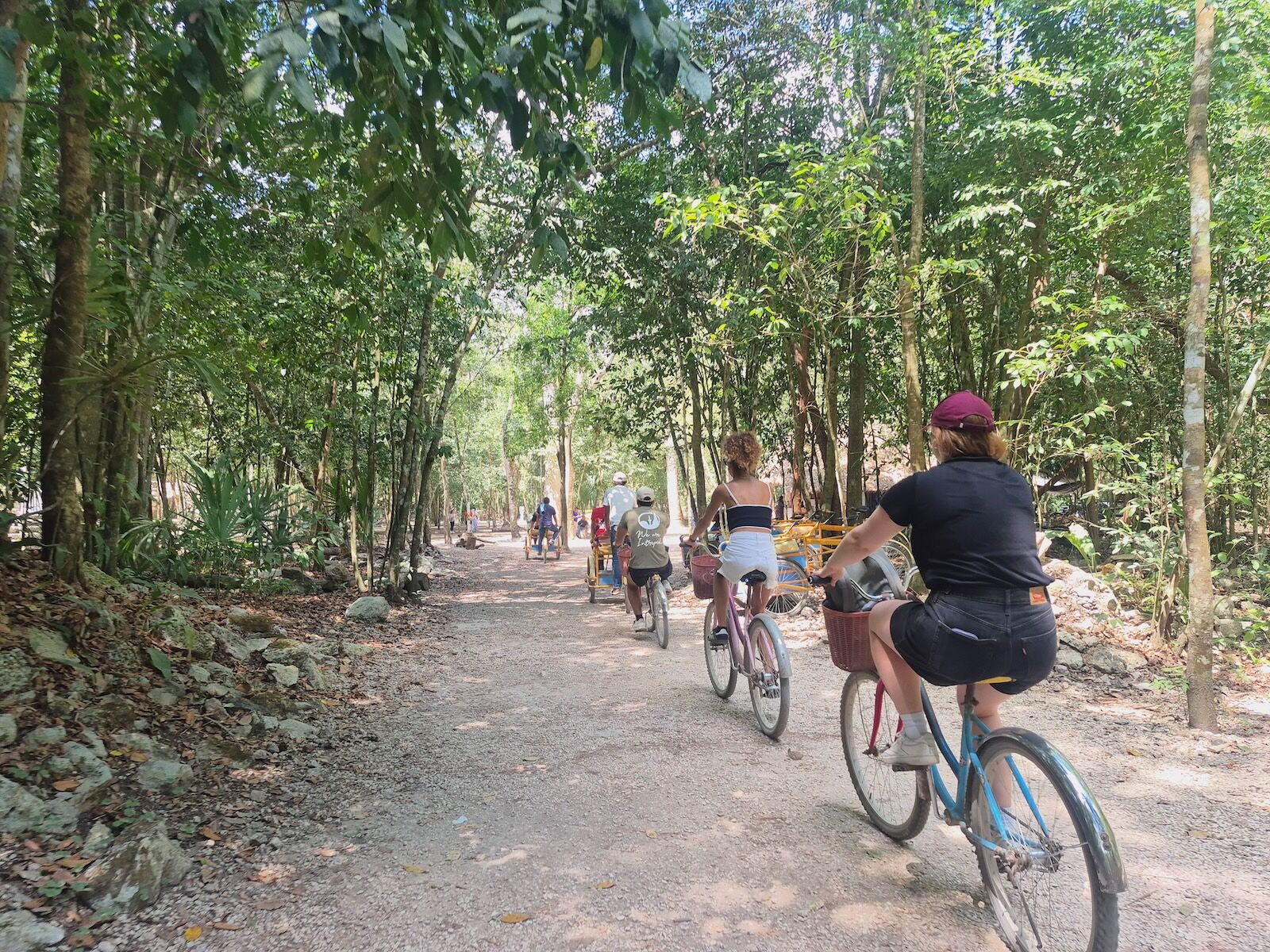 travelers biking into Cob&aacute; Archaeological Site 