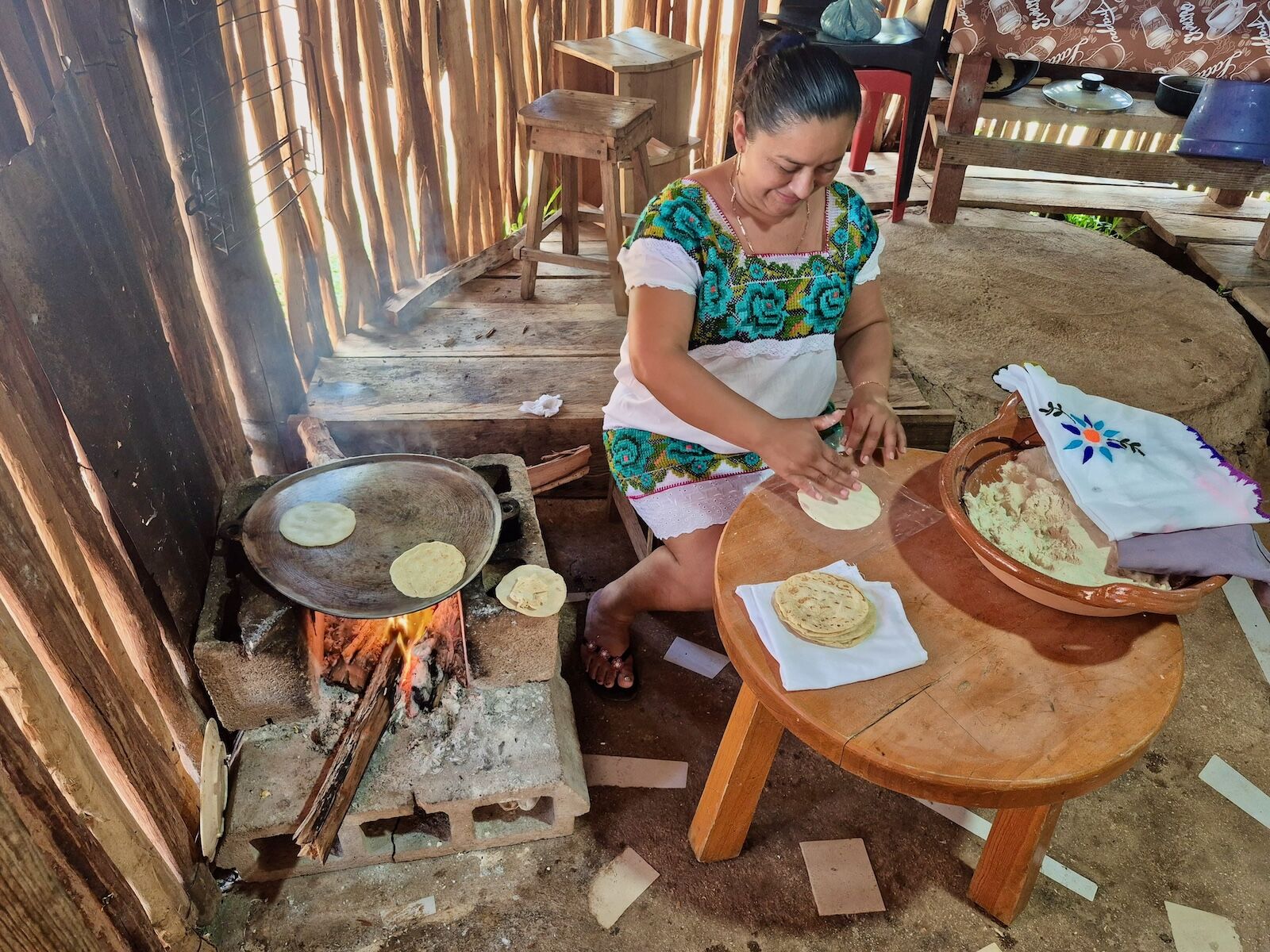 woman making tortillas on comal