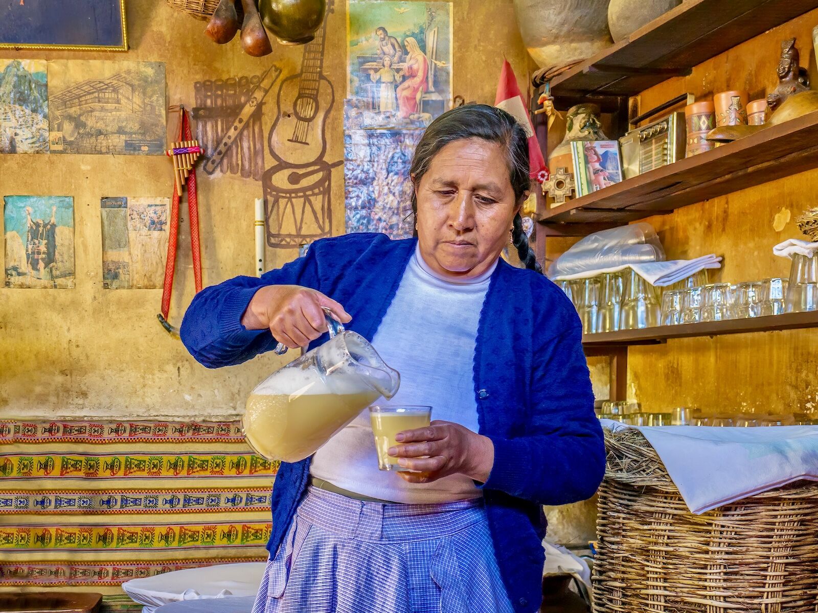 woman pouring chicha in peru